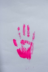 Pink handprint on grey paper