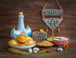 Still life on Nauryz (spring New Year's holiday) with Torsyk (a jug for koumiss), tolkan (coarse flour from fried barley or wheat), tary (fried millet), tumar (amulet), kurt, drink nauryz-kozhe