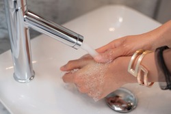 lady washing her hand from tab water