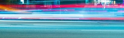 long exposure tracer cars lights. blue and red color lines from vehicles headlights. blurred fast moving transport. night city road traffic. abstract vibrant color dark time city life wide picture.