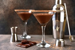 Delicious chocolate martini in a glasses on a dark slate, stone or concrete background.