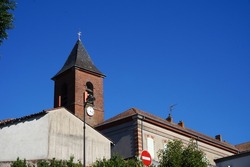 Brick bell tower of the 19th century Saint-Georges' Church in Saint-Juéry, on top of the hill in the upper part of the old town, which is located in Southwestern France, next to the city of Albi