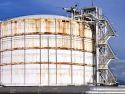 Refinery crude oil storage tanks at large, with the old rust and corrosion from the session.