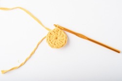Yellow crochet circle on a white background