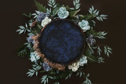Newborn digital background - brown wooden bowl with green leaves wreath,  teal flowers and blue faux fur.