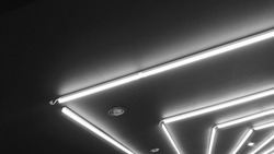Black and white of neon lighting decoration under gypsum false ceiling. Neon light bulb linear type illuminated background