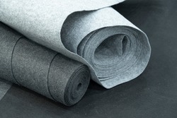Close up of carpet rolls. Polyester or felt carpets background