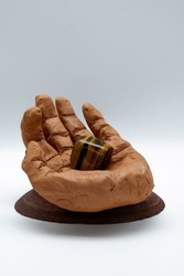 Clay hand sculpture with tiger's eye stone