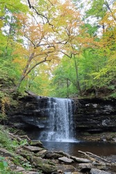 Waterfall in Autumn cascading down rocks in Ricketts Glenn Pennsylvania