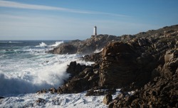 Panoramic view of lighthouse Faro de Cabo Roncudo on Costa da Morte rock coast shore in Ponteceso A Coruna Galicia Spain
