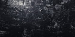 Black concrete wall. Texture old dark stone background. Vintage anthracite wallpaper. Old scratched dark grunge plaster texture. Black cement background with white scuffs. Long Web banner