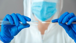 Covid 19 pcr test in nurse hands. Doctor in protective suit medical mask gloves holding Swab saliva sample for diagnostic covid19 coronavirus virus in lab. Nasopharyngeal culture pcr test. Web Banner.