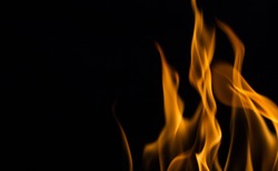 Yellow fire flames, isolated on black background,