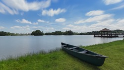 Scenery of beautiful cloud with canoe rests on a shore. Wetland Putrajaya Lake