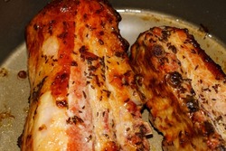 juicy roasted pork ribs with cumin after baking still in the roasting pot