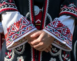 Elements of traditional Bulgarian folk costume with embroidery. A Female singer from Trakia folk ensemble and details of old, traditional dress. Photographed in Plovdiv, Bulgaria