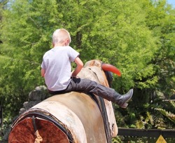 Young Boy Riding Mechanical Bull