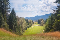 A summer day at Kokanee Springs Golf Resort golf course with view of Selkirk Mountains in Crawford Bay, British Columbia, Canada.