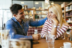 Beautiful couple in love flirting in restaurant and bonding