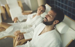 Beautiful couple relaxing in spa center
