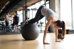 Beautiful woman training pilates in gym