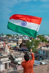  indian young man holding tricolour flag