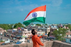  indian young man holding tricolour flag