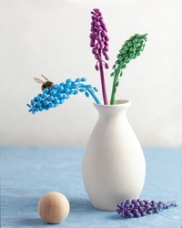  Art concept. Modern still life with colored flowers and a bee. The concept of summer, spring, fashion. Copy space.