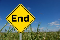 end written on a yellow road sign and copyspace for text