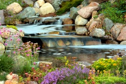 A perfect cascade of water over the rocks in a garden