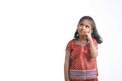Indian little girl in traditional wear and giving expression on white background.