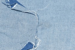 Blue denim jean ripped texture with seam fabric