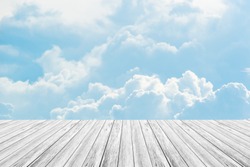 Cloudscape of natural sky with blue sky and white clouds in the sky use for wallpaper background with wood table or terrace