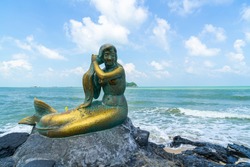 golden mermaid statues on Samila beach. Landmark of Songkla in Thailand.