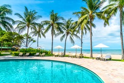 Beautiful tropical beach and sea with umbrella and chair around swimming pool in hotel resort for travel and vacation