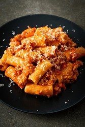 Bolognese rigatoni pasta with cheese - traditional Italian pasta