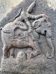 God riding in an Elephant sculpture. Bas relief sculpture carved in the stone walls of Shiva temple, Tamil nadu