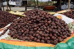 Indian dried jujube jungli Ber sold in Vegetable market. Bora or Ber wild jungle fruit selling by villagers big heap wholesale market in a Village road side highway market in Maharastra India