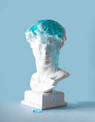 Blue transparent slime dripping off the plaster bust of a beautiful young man. Minimal creative concept , popular art mass consumption. 