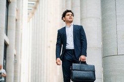 The financier is in a hurry to meet with colleagues. A bank employee near the office. An economist goes to work in a business suit. The lawyer is happy with a briefcase in his hands.