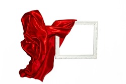 Flying red satin cloth unveiling a white vintage frame. Levitating frame, mockup for presentation or display.