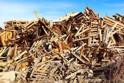 Waste pile of scrap old pallets and wood shipping containers to be burned in a bonfire.