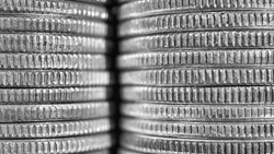 Stacks of US American coins of 25 cents quarters closeup. Black and white background or wallpaper about economy finance banks in the USA. Old money from circulation. Macro