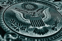 1 US dollar. Fragment of banknote. Reverse of bill with the Great Seal. The bald eagle is the national symbol. Dark blue-green inverted background. American treasury and treasuries. Economy of the USA