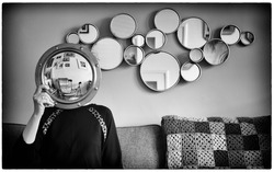 Art photo with mirror used as face and lots of round mirrors