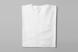 Mockup of top view perspective white blank folded t-shirt template in studio photo shoot on grey background