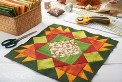 Patchwork orange-green block, quilting fabrics, sewing accessories