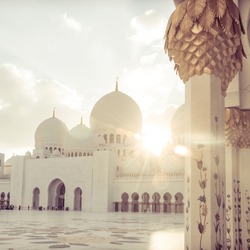 Beautiful sun rays beaming through spectacular domes of a mosque. Beautiful Islamic religious background.