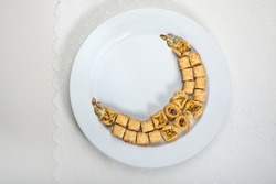 Baklava - A popular Middle Eastern sweet, arranged in a moon shape. Conceptual photo for Eid special sweets and dessert.