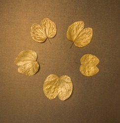 Dussehra greeting card cover with clear space for message.  Golden Apta leaves - a symbolic ‘gold’, arranged in a circular shape with empty space for logo or text.